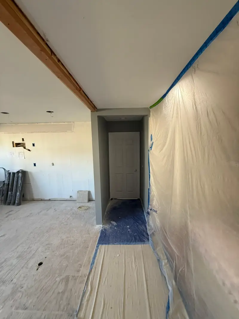 Homeowner photographing a wall for a virtual painting estimate
