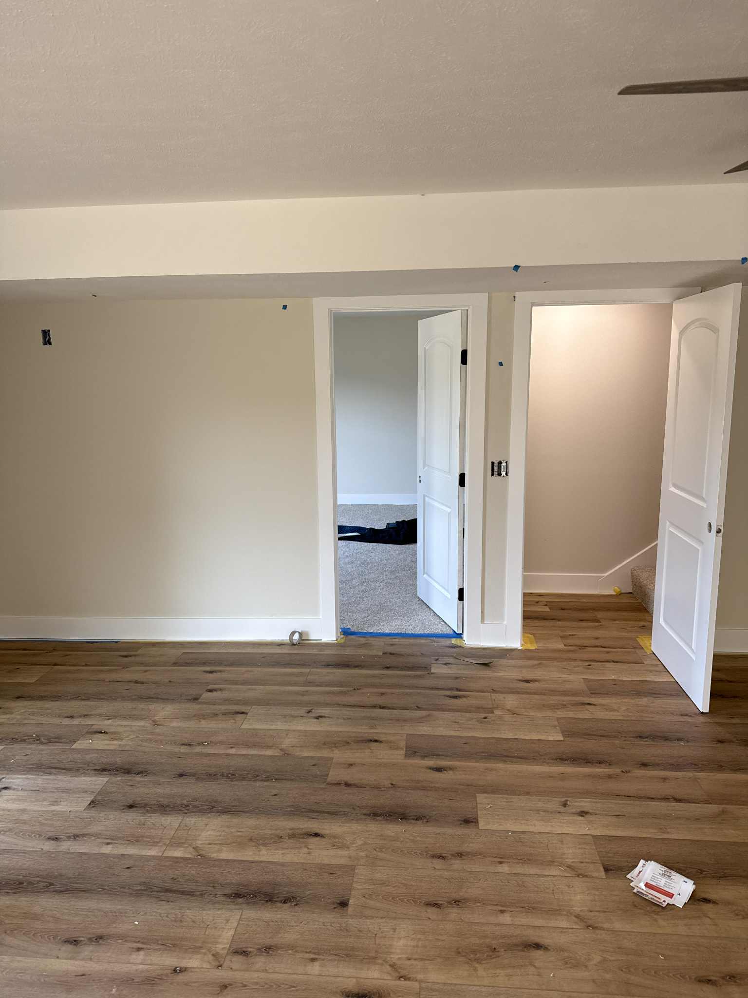 Freshly painted room with white trim and wood floors